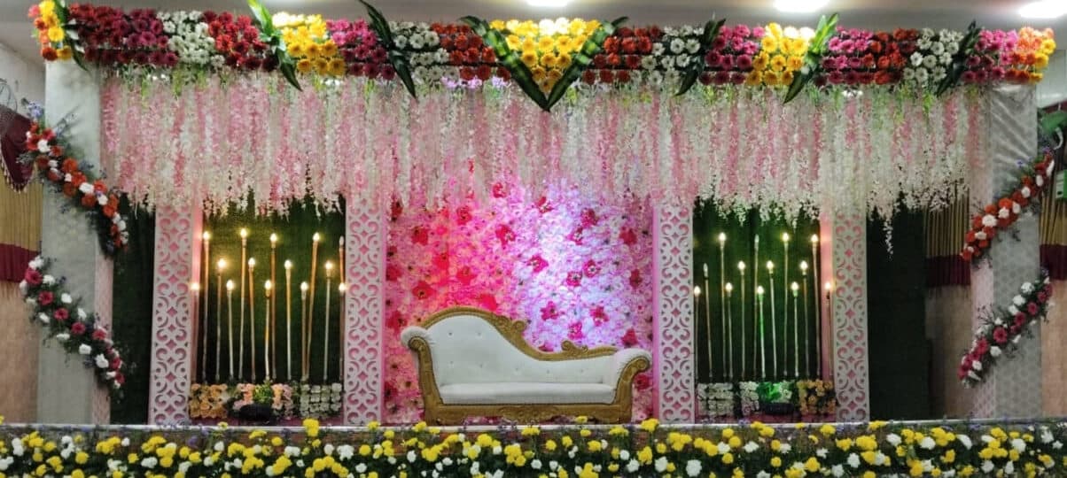 Grand wedding stage with fairy lights and floral drapes