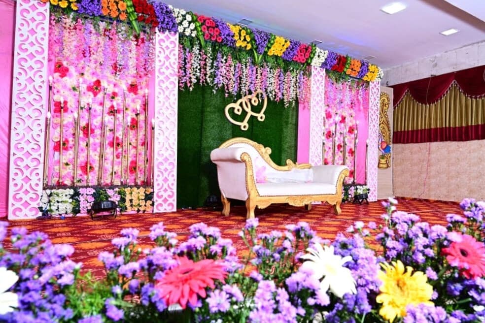 Pink wedding stage with golden hearts and chaise lounge